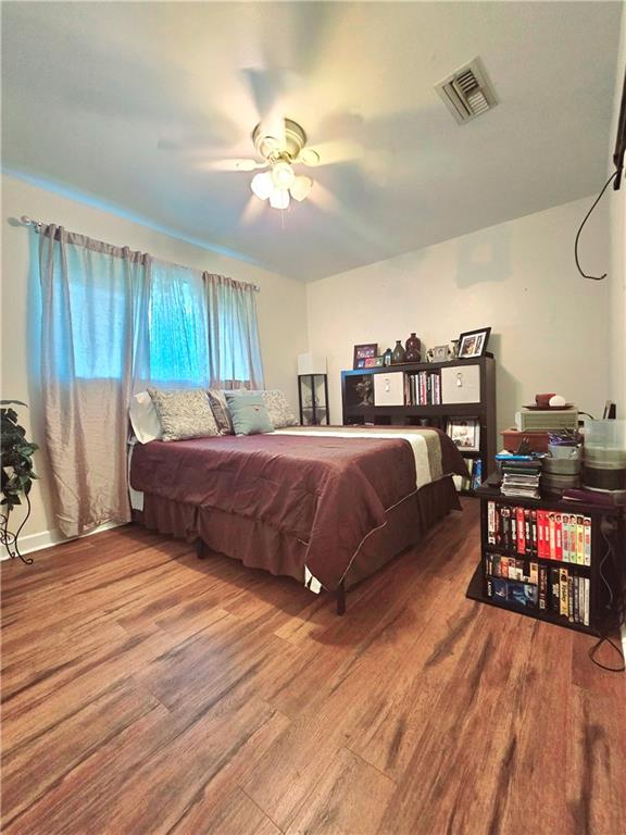 bedroom featuring ceiling fan and wood-type flooring