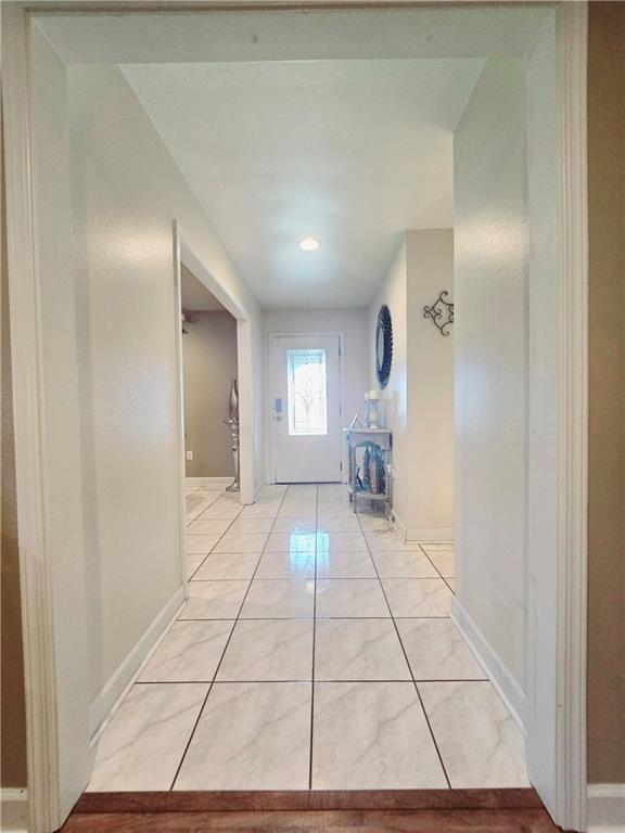 hallway featuring light tile patterned floors