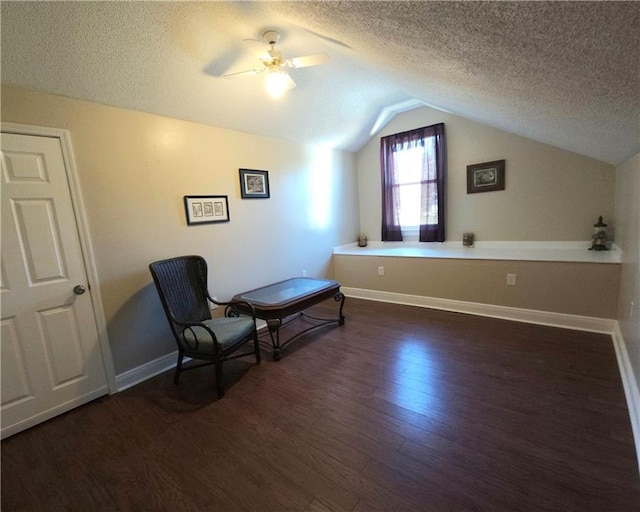 unfurnished room with a textured ceiling, dark hardwood / wood-style floors, ceiling fan, and lofted ceiling