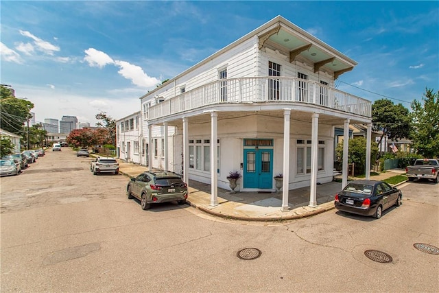 view of front of house featuring french doors and a balcony