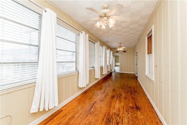 corridor with hardwood / wood-style floors