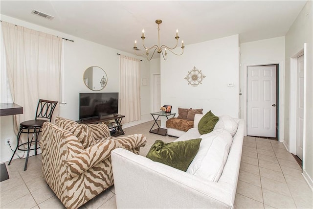 living room featuring a notable chandelier and light tile patterned floors