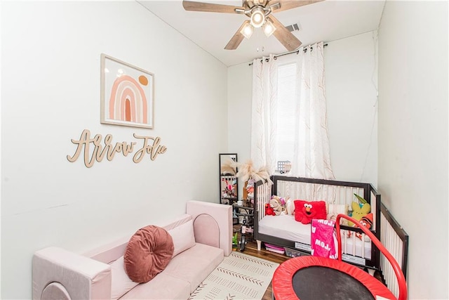 living area with hardwood / wood-style flooring and ceiling fan