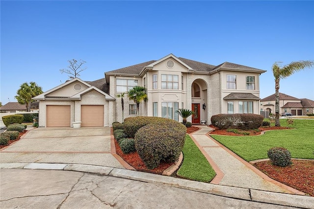 view of front of home with a front yard and a garage