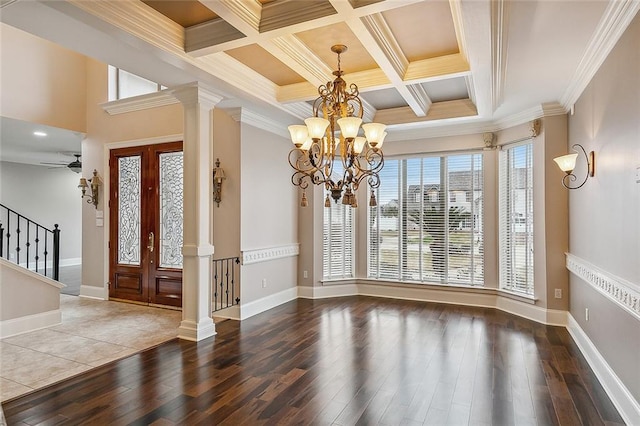 entrance foyer featuring ceiling fan with notable chandelier, wood-type flooring, coffered ceiling, and ornate columns