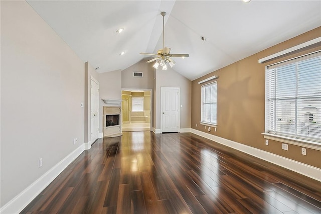 unfurnished living room with dark hardwood / wood-style floors, ceiling fan, and plenty of natural light