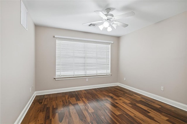 spare room with ceiling fan and dark wood-type flooring