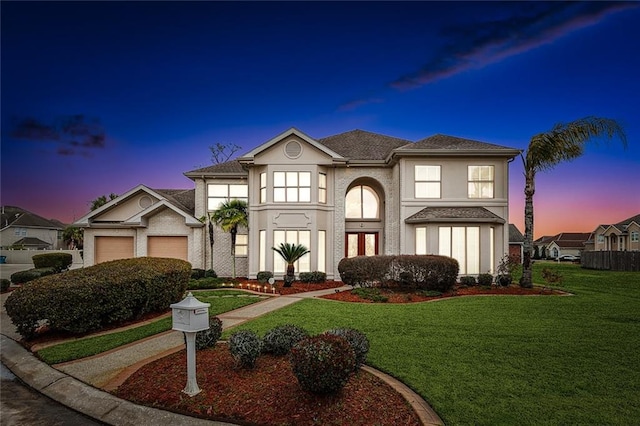 view of front facade featuring a garage and a lawn