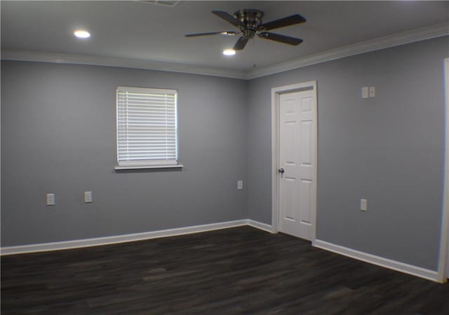 empty room featuring ceiling fan, crown molding, and dark hardwood / wood-style flooring