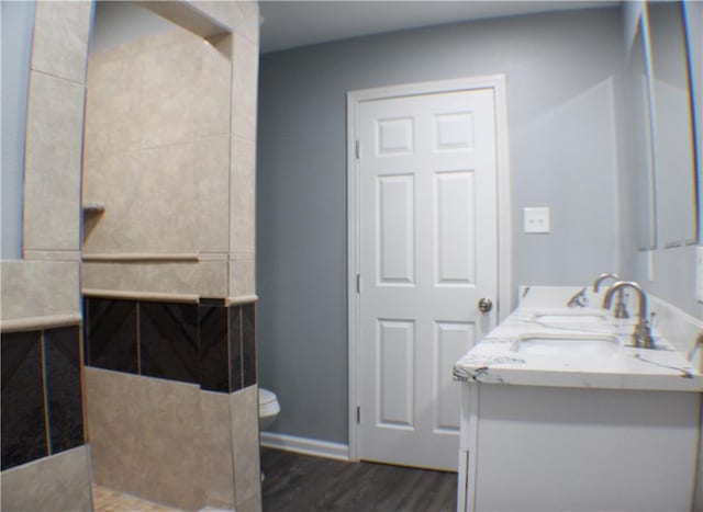 bathroom featuring hardwood / wood-style flooring, vanity, and toilet