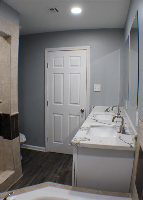 bathroom featuring hardwood / wood-style floors, vanity, and toilet