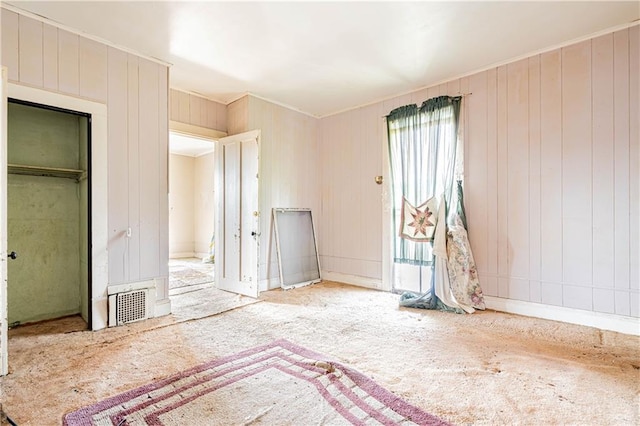 unfurnished bedroom featuring multiple windows, carpet, and a closet