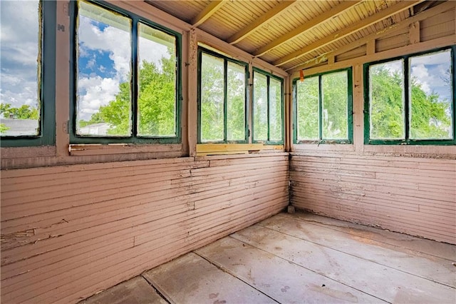 unfurnished sunroom featuring vaulted ceiling