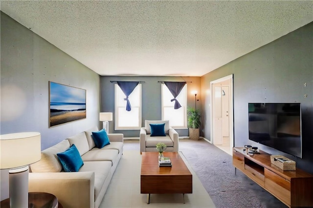 living room featuring a textured ceiling and carpet floors