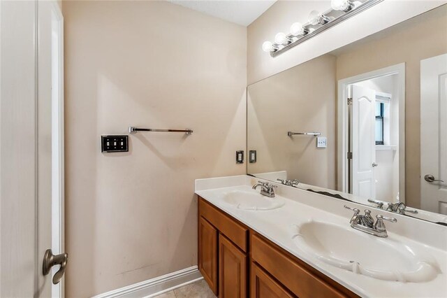 bathroom with tile patterned floors and vanity