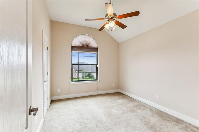 carpeted empty room featuring lofted ceiling and ceiling fan