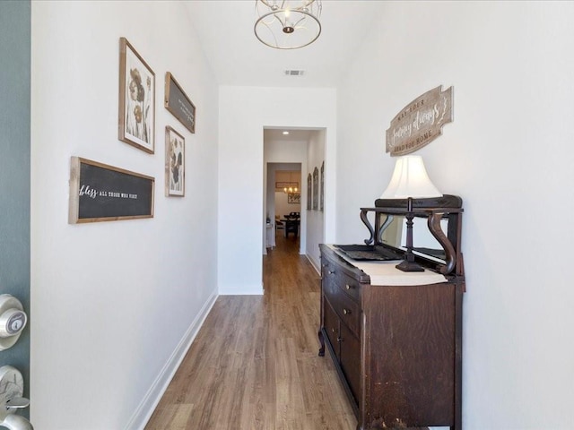 hallway with light hardwood / wood-style flooring