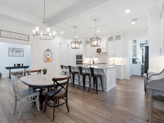 dining area featuring wood-type flooring and a chandelier