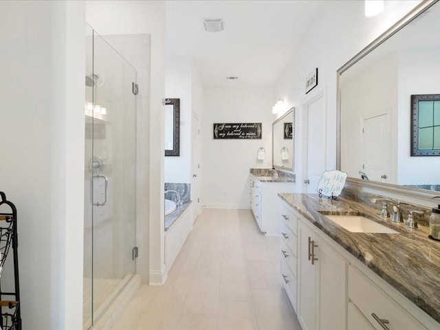 bathroom featuring tile patterned flooring, shower with separate bathtub, and vanity