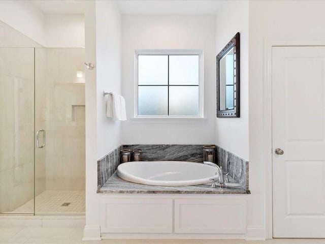 bathroom with a healthy amount of sunlight and shower with separate bathtub