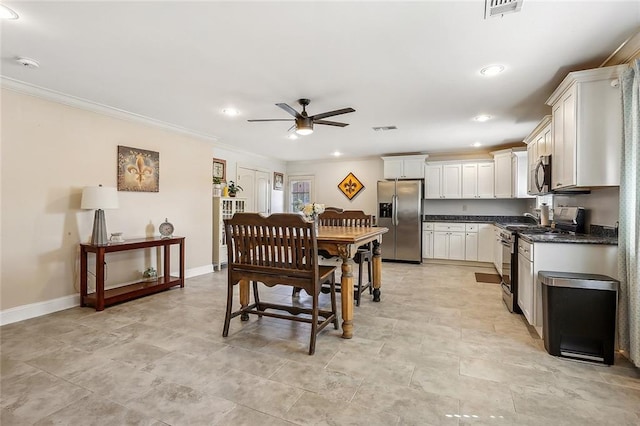 dining room featuring ceiling fan, light tile patterned floors, and ornamental molding