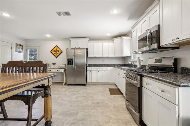 kitchen with white cabinets, crown molding, stainless steel appliances, sink, and light tile patterned flooring