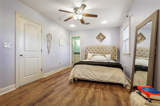 bedroom with ensuite bathroom, ceiling fan, and dark hardwood / wood-style floors