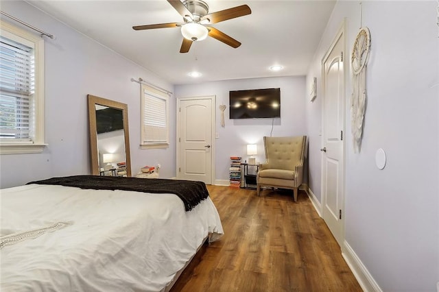 bedroom featuring ceiling fan and dark hardwood / wood-style floors