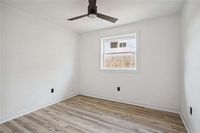 empty room with ceiling fan and light hardwood / wood-style floors