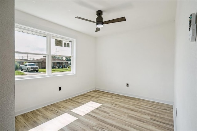 spare room featuring ceiling fan and light wood-type flooring