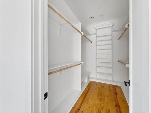 spacious closet with light wood-style floors and visible vents