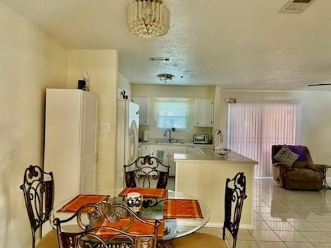 tiled dining room with sink