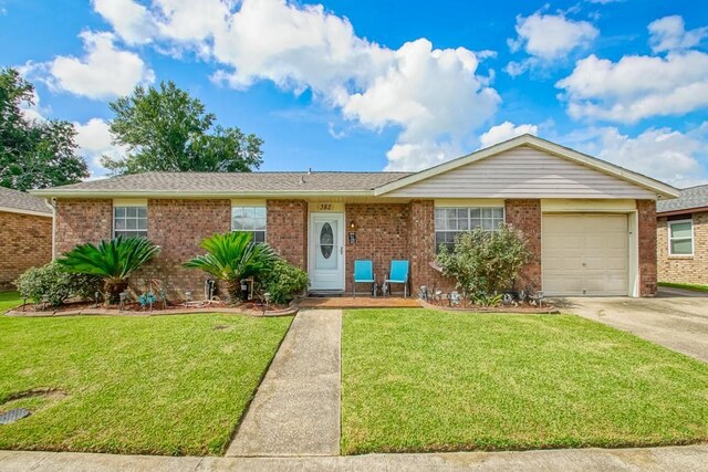 ranch-style home featuring a front yard and a garage