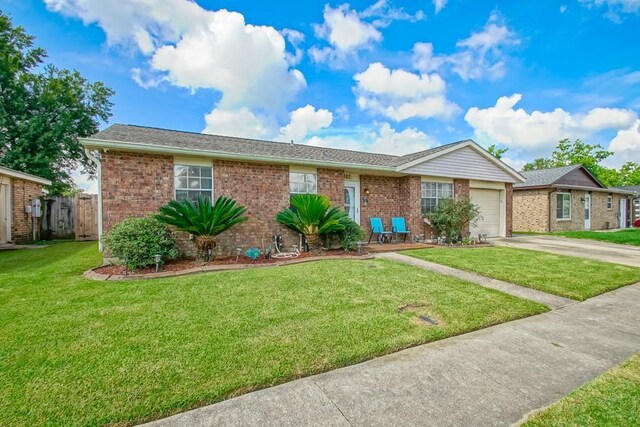 ranch-style house with a garage and a front lawn