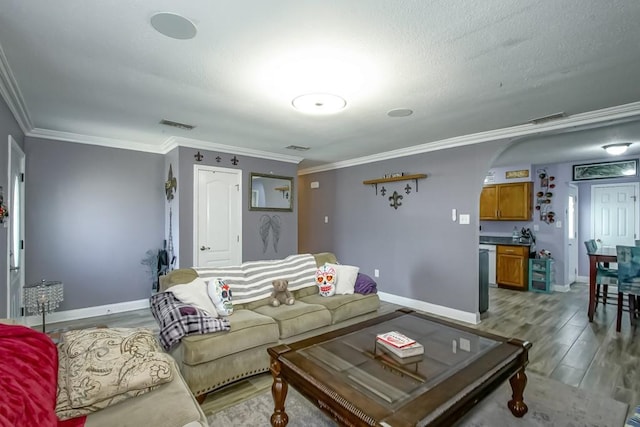 living room with crown molding and light hardwood / wood-style flooring