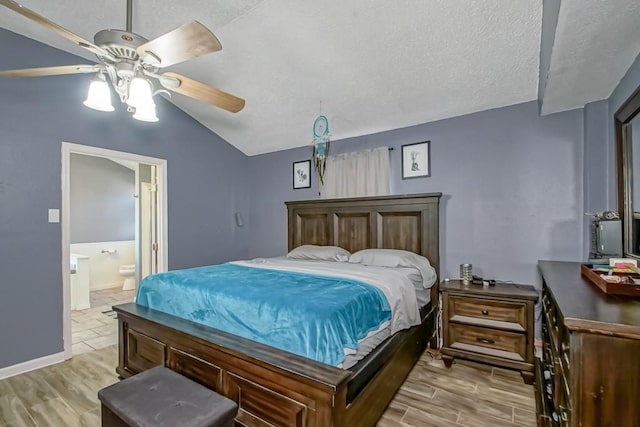 bedroom featuring a textured ceiling, light hardwood / wood-style floors, connected bathroom, lofted ceiling, and ceiling fan