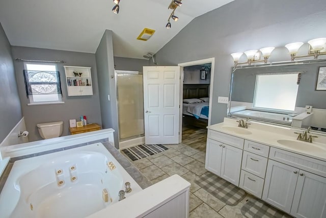 bathroom featuring lofted ceiling, tile patterned floors, independent shower and bath, and vanity