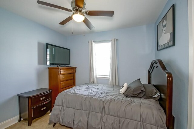 bedroom featuring light colored carpet and ceiling fan