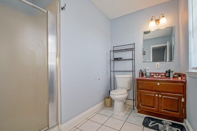 bathroom with vanity, toilet, an enclosed shower, and tile patterned floors