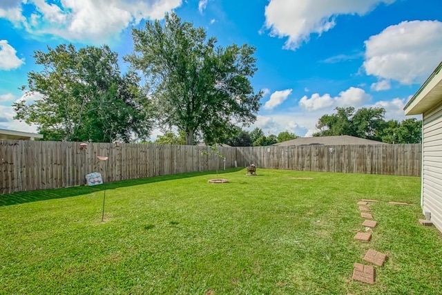 view of yard with a fenced backyard