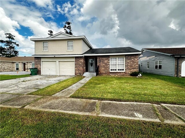 view of front of house with a garage and a front lawn