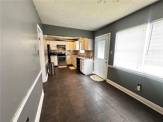 kitchen featuring a textured ceiling, dishwasher, electric stove, and dark tile patterned floors