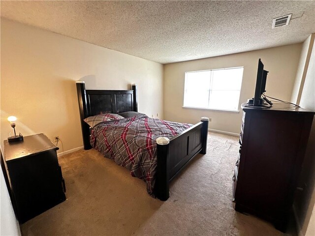 carpeted bedroom with a textured ceiling