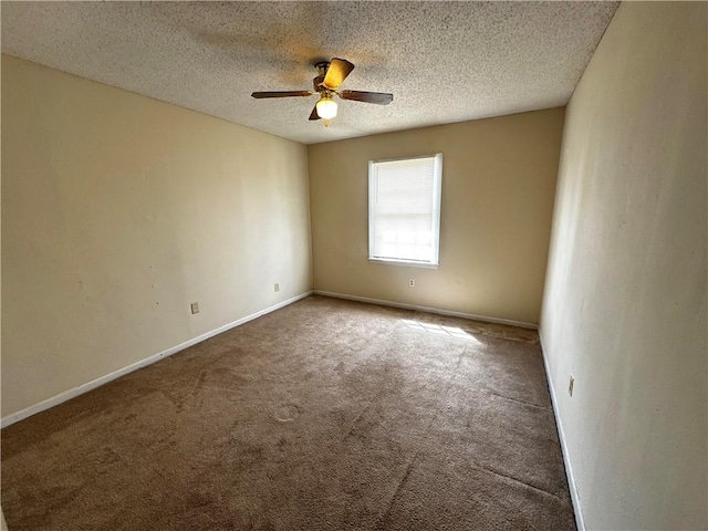 spare room featuring carpet flooring, a textured ceiling, and ceiling fan