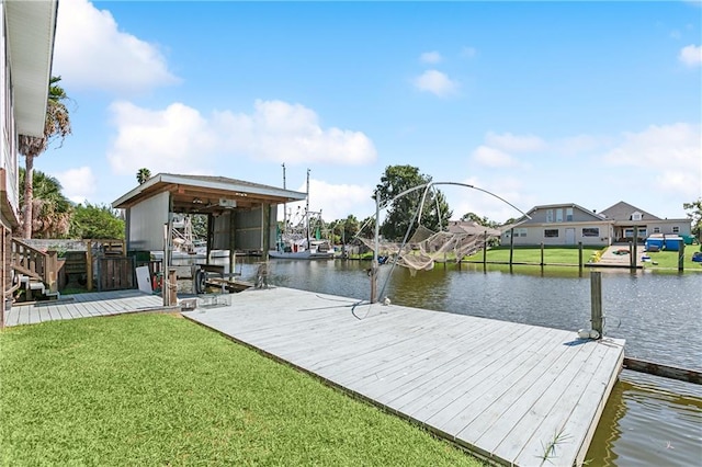 dock area with a water view and a yard