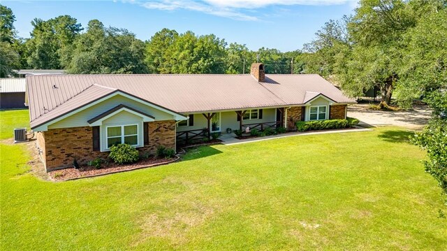 ranch-style home featuring central AC and a front yard