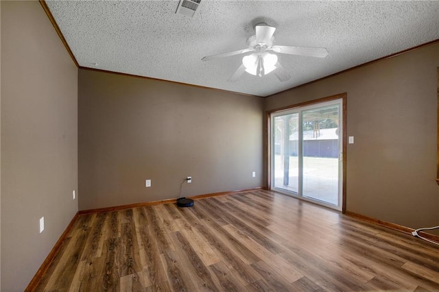 empty room featuring ornamental molding, a textured ceiling, hardwood / wood-style floors, and ceiling fan