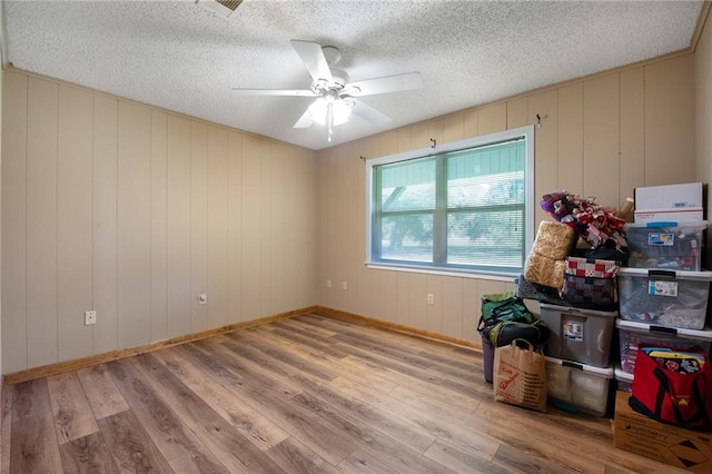 interior space with ceiling fan