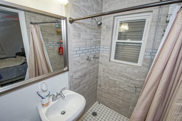 bathroom with a shower with shower curtain and sink