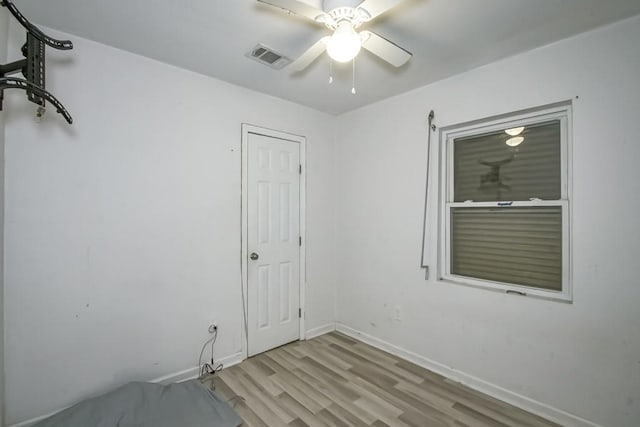 clothes washing area with light hardwood / wood-style flooring and ceiling fan